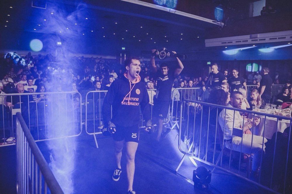 Nick carrying a victorious fighter in the cage