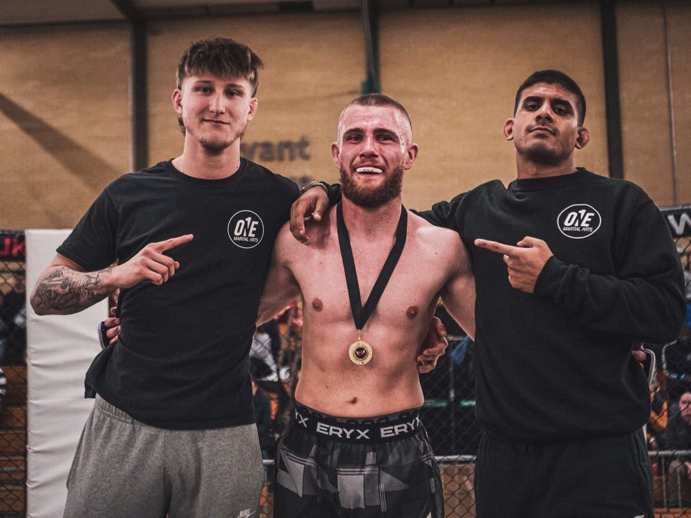 Medal-winning fighter with his coaches